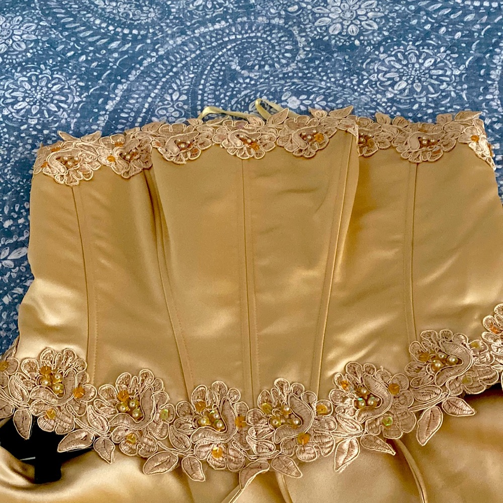 This is a two piece formal ensemble! It is gold and embroidered with gems.